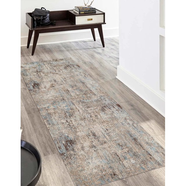 ECARPET Malia traditional runner rug featuring a distressed beige, brown, and blue pattern placed on light wood flooring in an entryway setting.