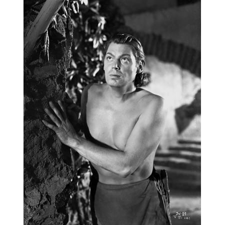 - Johnny Weissmuller Hiding Behind a Rock Wall in a Portrait Photo Print