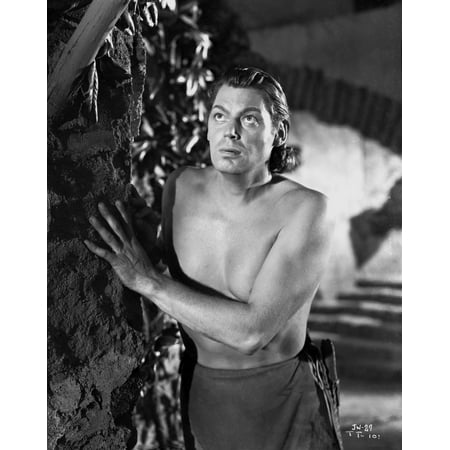 Johnny Weissmuller Hiding Behind a Rock Wall in a Portrait Photo (Johnny Depp Best Photos)