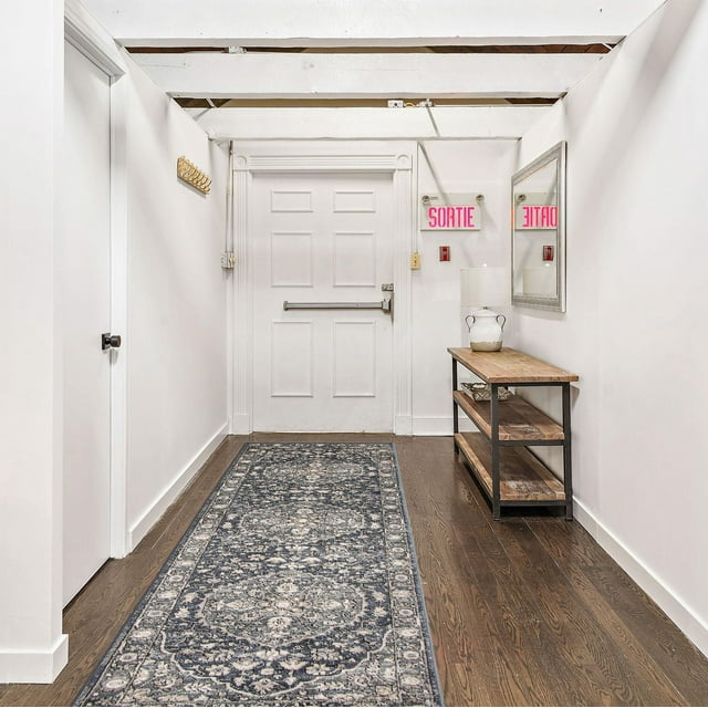 ECARPET Vintage Oriental Area Rug from Oregon Tabriz Collection featuring detailed blue and beige floral motifs, placed as a runner on hardwood floor in a bright white hallway.