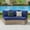 Blue, variant on Jocisland Rattan PE Patio Storage Side Table Sofa Wedge End Table with Tempered Glass Top, Brown