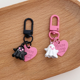 thumbnail image 1 of Colgante de diablillo dulce y genial con personalidad linda, colgante de botón redondo rosa y negro, llavero, colgante de auriculares, 1 of 5