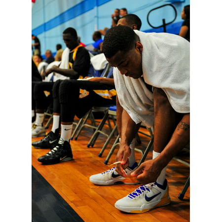 Canvas Print Montavious Waters, guard for the All-Army basketball team ties his shoes before the game at the Chap Stretched Canvas 10 x (The Best Basketball Shoes For Shooting Guards)