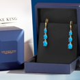 thumbnail image 5 of Gem Stone King 18K Yellow Gold Plated Silver Blue Opal 3 Stone Dangle Earrings for Women (4.38 Cttw, Gemstone October Birthstone, Oval Cabochon 8X6MM, 7X5MM and 6X4MM), 5 of 6