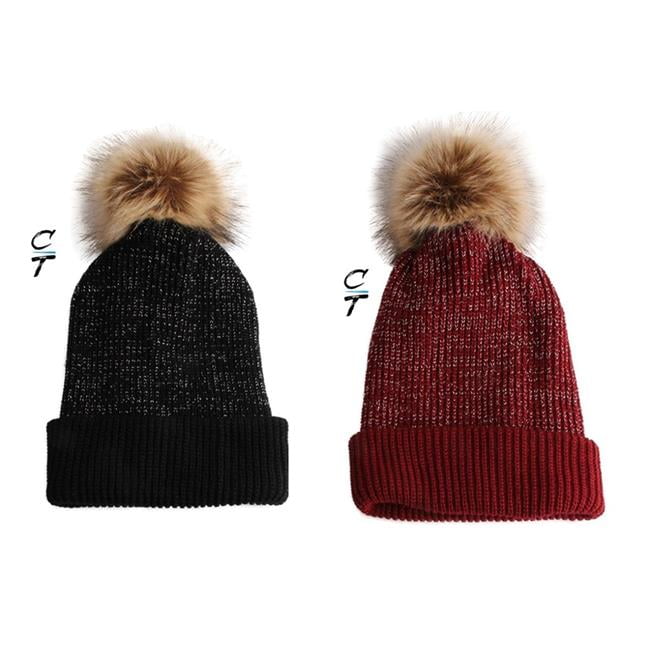 black hat with brown pom pom