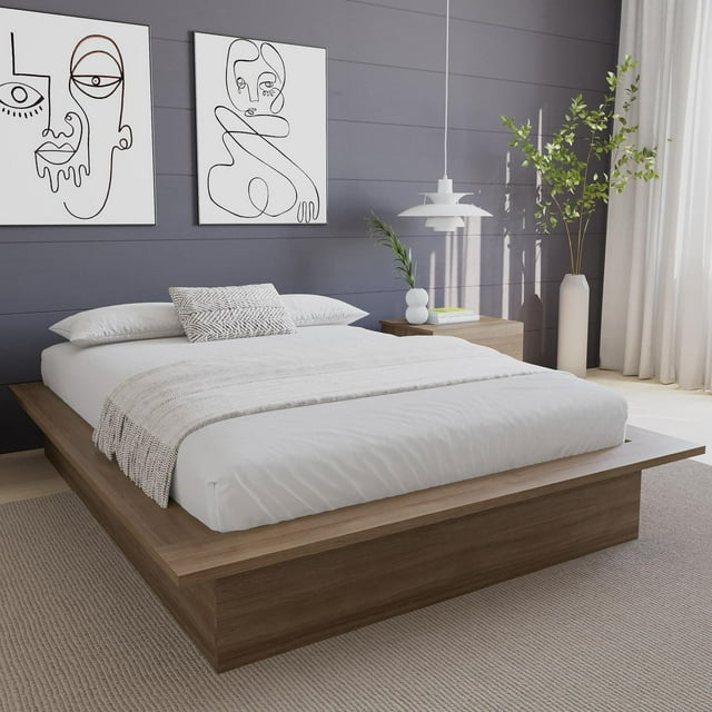 Nexera Malibu Platform Bed Frame in wood finish with white bedding, set against a gray paneled wall and minimalist decor.