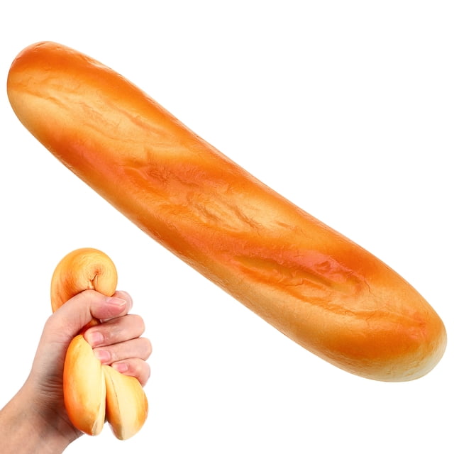 pan falso simulación de pan artificial modelo de comida decoración cocina prop (baguette) Amarillo, baguette artificial de 28 x 6 x 3 cm en vista frontal centrada con textura de corteza y brillo suave hecha en material PU; inserto muestra mano comprimiendo el pan para evidenciar elasticidad. Ideal como accesorio fotográfico y juguete didáctico.