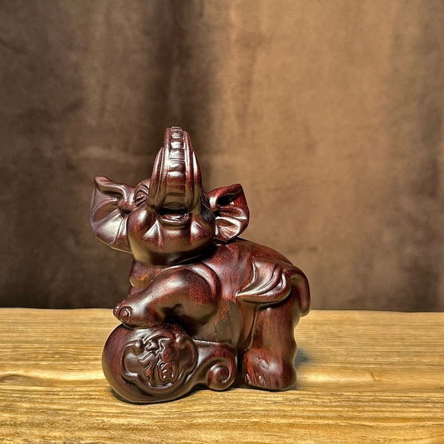 A pair of ebony wood carved elephant figurines for home, office, decorative crafts, shop openings, or as gifts for new homes.