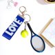 thumbnail image 1 of Llaveros con forma raqueta tenis para bolsos, ideales para familiares, amigos y aficionados . Regalo para Valentín. Azul, 1 of 8