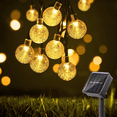 thumbnail image 1 of Guirnaldas de luces solares, 50 luces LED decorativas con bolas de cristal para exteriores de 23 pies para jardín, patio, Navidad, 1 of 5