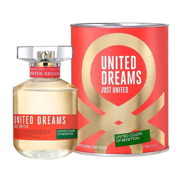 perfume just united de united colors of benetton edt 80 ml — Frasco de vidrio cilíndrico con líquido ámbar y etiqueta roja que dice "UNITED DREAMS JUST UNITED", tapa transparente y atomizador visible; incluye estuche metálico rojo y dorado con el mismo texto, fondo blanco. Presentación 80 ml para dama.