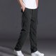 thumbnail image 1 of Pantalones largos de poliéster para hombre, de color liso, informales, con botones, cintura elástica y múltiples bolsillos., 1 of 9