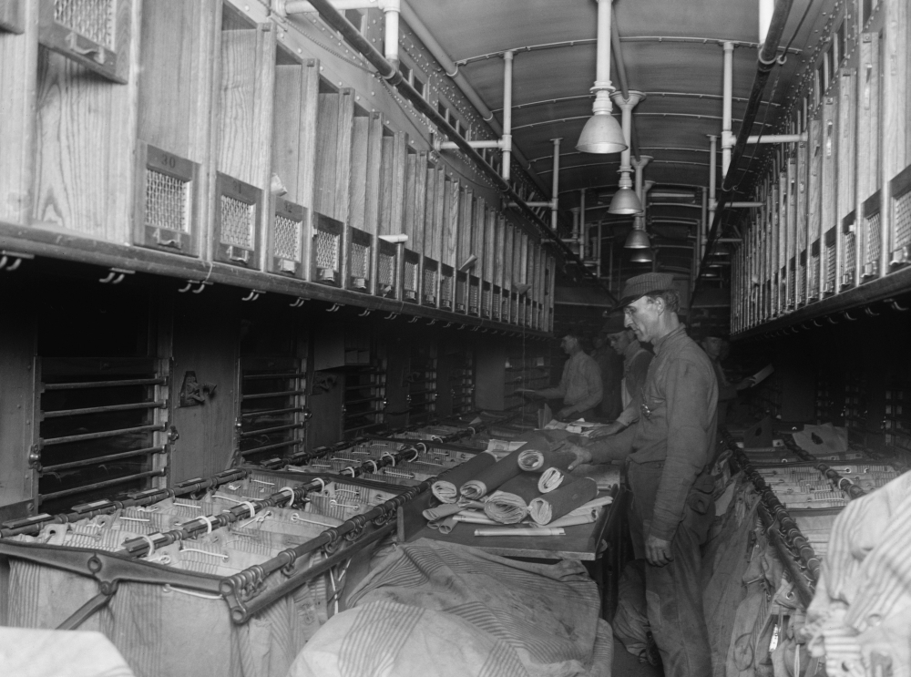 Railway Post Office Clerks Sorting Mail Aboard A Customized Rail Car In