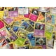 thumbnail image 1 of Cartas coleccionables Pokémon, 50 surtidas, con láminas holográficas adicionales, 1 of 1