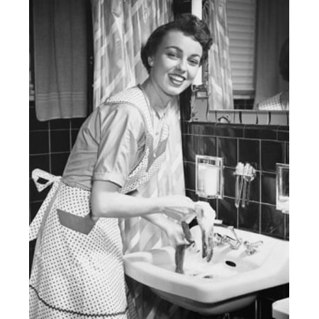 Portrait of a young woman hand washing clothes in the bathroom sink Stretched Canvas -  (24 x
