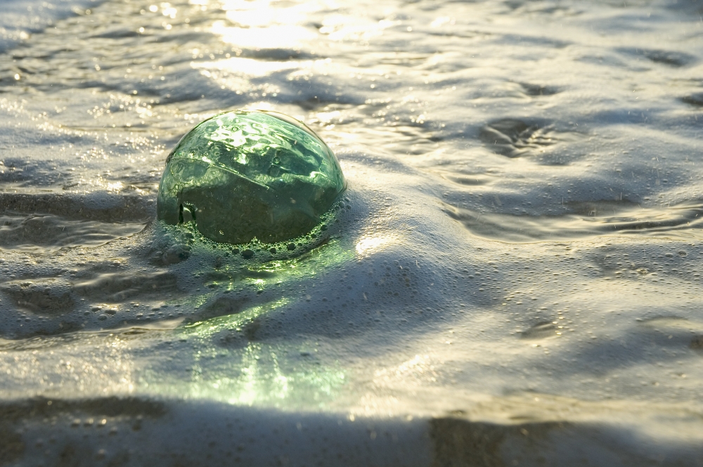 A Glass Fishing Ball Floats In Shallow Water, Bright Reflections Poster