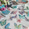 thumbnail image 3 of Pegatinas de mariposas holográficas al por mayor - 160 piezas, transparentes, brillantes, con contornos de lámina dorada 3D para manualidades., 3 of 4