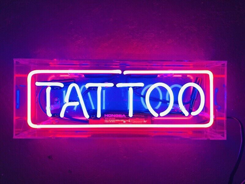 Tattoo studio neon text bright signboard Vector Image