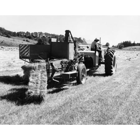 Farmer sitting on a tractor pulling hay baler in a field Canvas Art - (24 x 36)