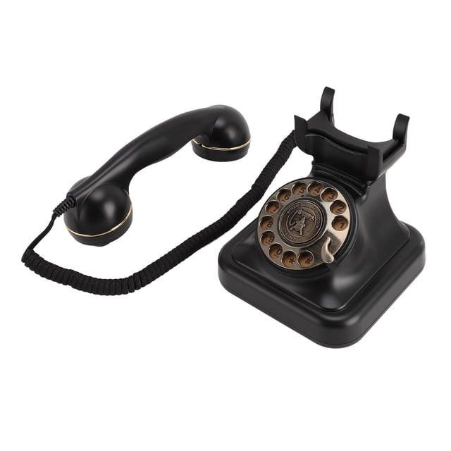 teléfono fijo retro teléfono mecálico retro de teléfono giratorio antiguo para la oficina en casa Negro Anggrek, vista frontal 3/4 con auricular separado; base ABS negro con disco giratorio bronce, soporte para auricular, cable en espiral y anillos metálicos en el auricular; fondo blanco, para uso en hogar u oficina y suele emplearse como pieza decorativa en escritorios.