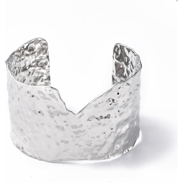 Pulsera rígida de acero inoxidable, ancha y abierta, con diseño irregular y llamativo. Ajustable, color plata. Ideal para la muñeca.