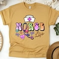 thumbnail image 1 of Nurse Life T-Shirt | Pastel Lettering with Stethoscope and Nurse Cap Graphic, Gold, Size 3XL, 1 of 6