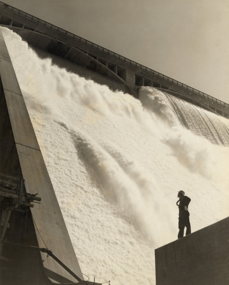 A Workman Inspecting The Grand Coulee Dam From The