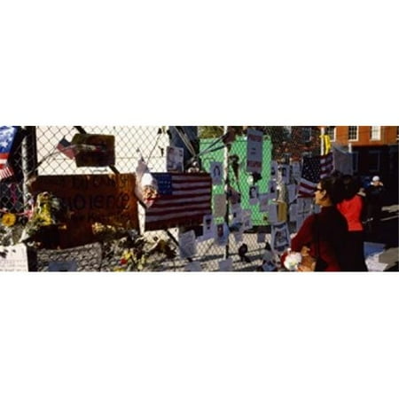 Side profile of a woman standing in front of chain-link fence at a memorial New York City New York State USA Poster Print by - 36 x 12