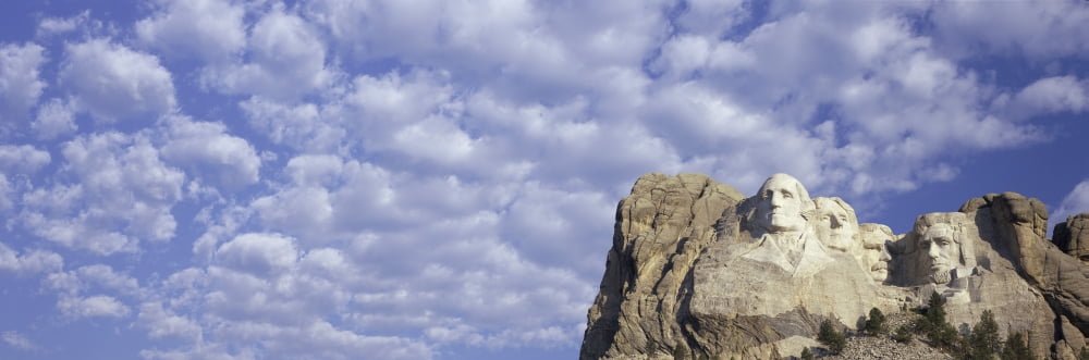 Panoramic image with white puffy clouds behind Presidents George Washington Thomas Jefferson Teddy Roosevelt and Abraham Lincoln at Mount Rushmore National Memorial South Dakota Canvas Art - Panoramic