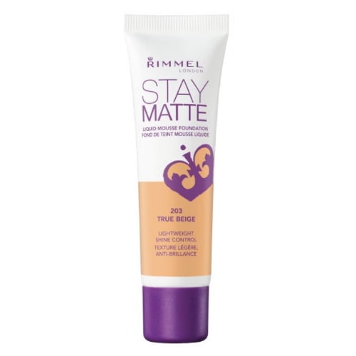Rimmel Stay Matte Foundation in 203 True Beige, a lightweight liquid mousse foundation with shine control and anti-pollution complex, in a white tube with purple cap and text, offering a matte finish and 24-hour wear for a flawless complexion.