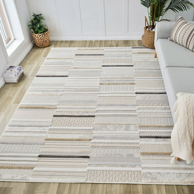 Modern beige and cream abstract indoor area rug with textured geometric patterns on light wood floor beside gray sofa in bright living room.