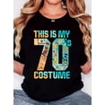 thumbnail image 1 of Camiseta con estampado gráfico retro de los 70 para mujer: "Este es mi disfraz de los 70" con símbolos de la paz y cintas de casete. Camiseta suave de cuello redondo y manga corta para mayor comodidad, 1 of 6
