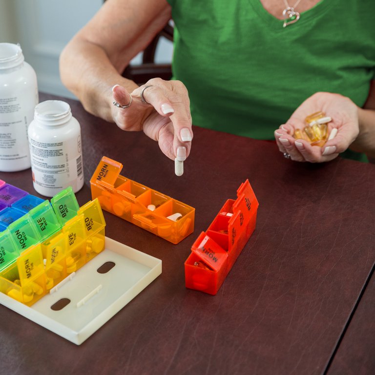 Nurse Preparing Weekly Pill Organizer Stock Photo - Download Image