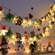 thumbnail image 1 of Hilo de luces navideñas LED con copos de nieve y campanas - Luces verdes decorativas de 200 cm alimentadas por pilas para decoración navideña interior, 1 of 6