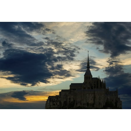 Silhouette of large stone Abbey perched on rocky hill with dramatic clouds at sunset Mont St Michel Brittany France Stretched Canvas - Michael Interisano  Design Pics (19 x