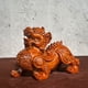 thumbnail image 1 of A pair of large solid wood carved Pixiu figurines, perfect for office, living room, or shop opening decorations., 1 of 3
