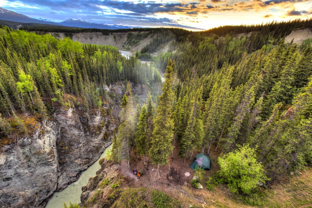 Scenic view of the Kuskulana River Canyon and Wrangell Mountains at sunset from the Kuskulana River Bridge on the McCarthy Road in Wrangell-St Elias National Park and Preserve Southcentral Alaska Spri