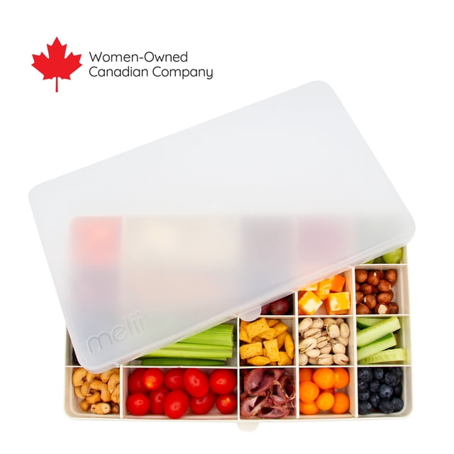 Melii Snackle XL divided snack container partially covered by a translucent lid showing compartments filled with healthy snacks like cherry tomatoes, celery sticks, nuts, cheese cubes and blueberries.