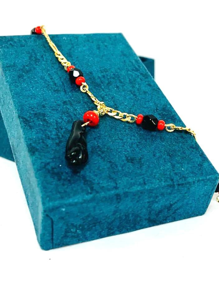 Baby bracelet with black hand deals meaning
