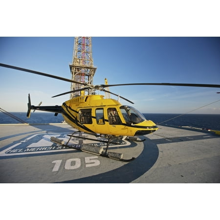 A Bell 407 utility helicopter on the helipad of an oil rig Canvas Art - Terry MooreStocktrek Images (35 x