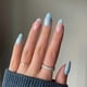 thumbnail image 1 of Uñas postizas azules almendradas con punta francesa y diseño floral, acrílico brillante de cobertura total., 1 of 5