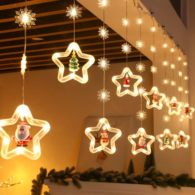 luz de cortina de estrella de cinco puntas, decoración de navidad, luz de color led, copo de nieve intermitente, barra de hielo, cadena de luz de estrella 3 metros, cortina frontal con estrellas de contorno LED de tono cálido y copos colgantes; cada estrella incluye una figura navideña interior (Papá Noel, árbol, muñeco de nieve), cable transparente y ganchos de suspensión, efecto de pared de luz para ventanas, porche o árbol; 8 modos de iluminación y conexión en cadena hasta 5 grupos; suele usarse también para decorar bodas y escaparates.
