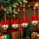 thumbnail image 1 of Adornos navideños con campanas de terciopelo rojo y lazos de hierro forjado para crear un ambiente festivo., 1 of 5