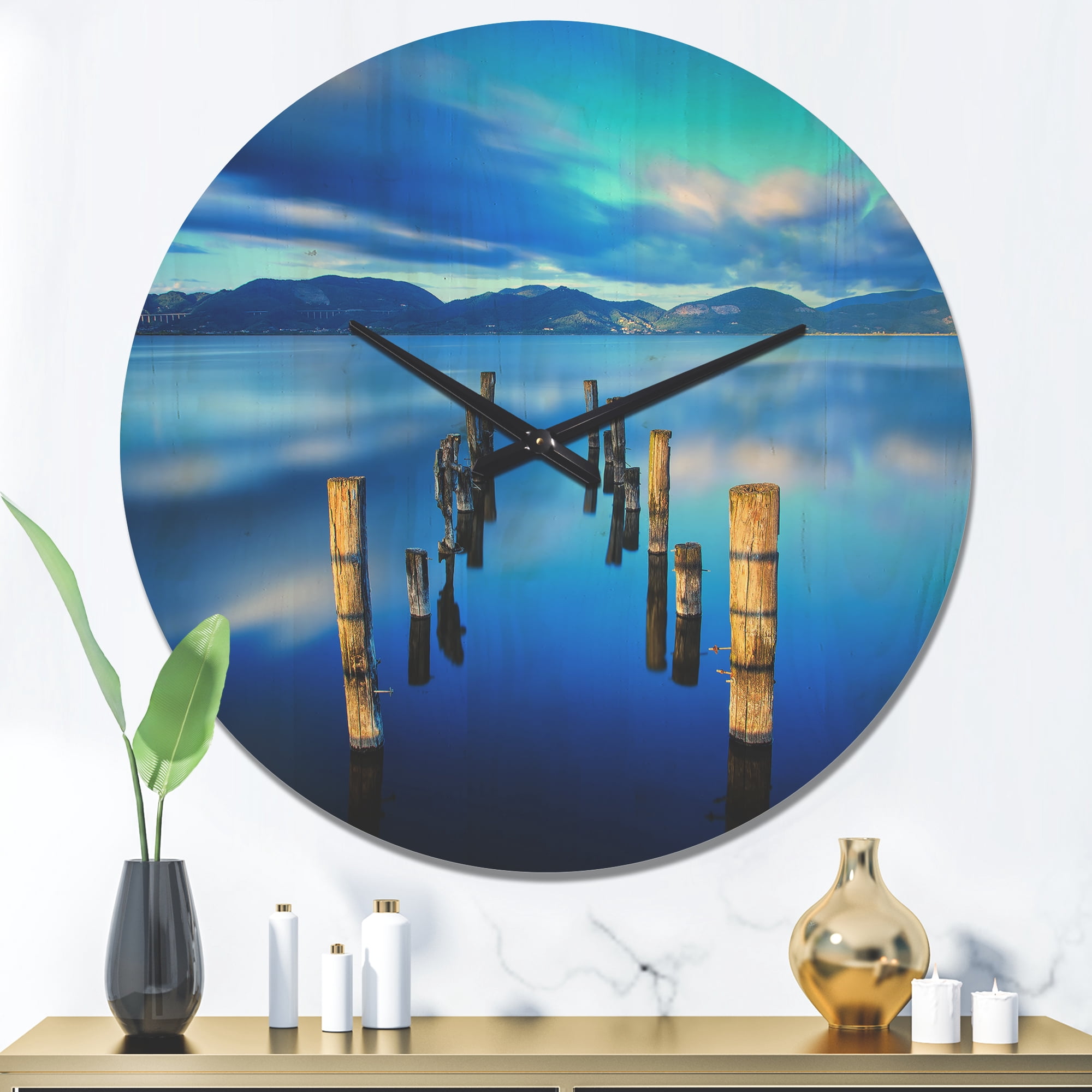 Designart 'Wooden Pier Remains in Blue Mountain Sea ' Modern Wood Wall Clock
