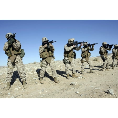 Military Transistion Team members quickly reload their rifles during an Enhanced Marksmanship Training simulation held on range 104 at Marine Corps Air Ground Combat Cenert Twentynine Palms Poster (Best Powder Measure For Rifle Reloading)