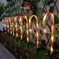 thumbnail image 1 of Muleta solar tricolor de Papá Noel con forma de estrella, copo de nieve, mango de paraguas, caramelo, luz LED para césped para exteriores, 1 of 6