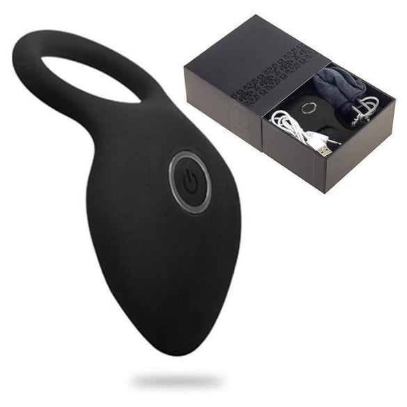 anillo del pene vibración recargable para los hombres con vibrador clítoris vibrante Anillo vibrador negro de silicona con aro elástico y punta ovalada, vista frontal centrada con botón de encendido visible; caja negra abierta con cable USB y manual. Diseñado para estimulación en la raíz y uso en pareja, y a menudo usado como accesorio de bienestar sexual en sesiones íntimas.