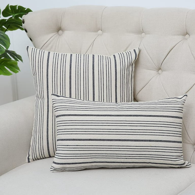 WHite and blue pillows accent a white linen couch placed in a