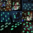 thumbnail image 1 of Pegatinas luminosas que brillan en la oscuridad con huellas navideñas, color verde y azul, para decoración de paredes, techos y dormitorios para Navidad, 1 of 4