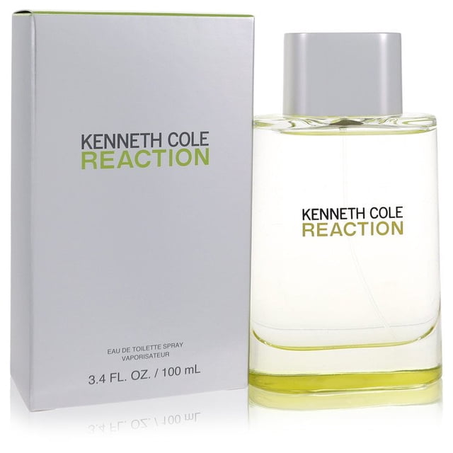 Kenneth Cole Reaction by Kenneth Cole Eau De Toilette Spray 3.4 oz, a men's fragrance in a sleek rectangular glass bottle with a silver cap and green accents. The fragrance box is displayed beside the bottle, featuring the Kenneth Cole Reaction branding in bold green and black text. This scent, introduced in 2004, blends musk, sandalwood, patchouli, green apple, and watermelon, offering a sharp and refined aroma.